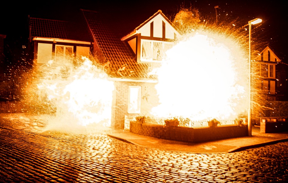 A house exploding in a fiery explosion.