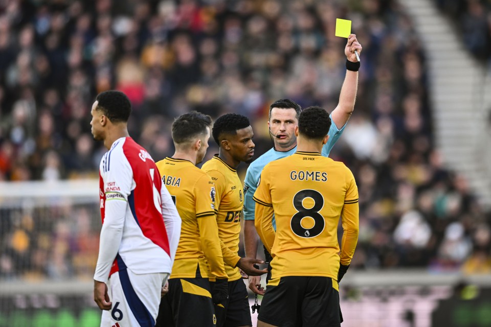 Referee showing Joao Gomes a yellow card.