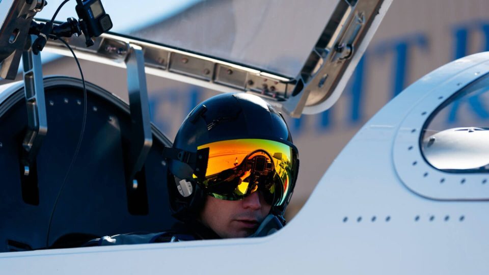 Test pilot in supersonic aircraft cockpit.
