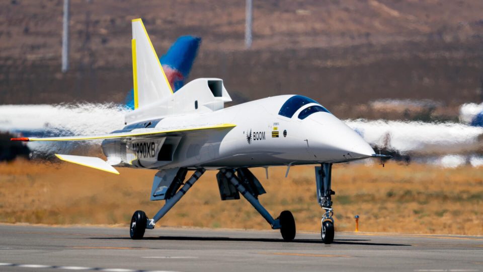 Boom Supersonic's XB-1 supersonic aircraft taxiing on a runway.