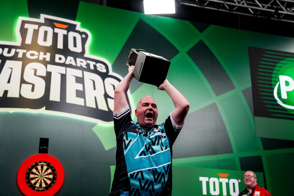 Rob Cross of England lifts the trophy after winning the TOTO Dutch Darts Masters.