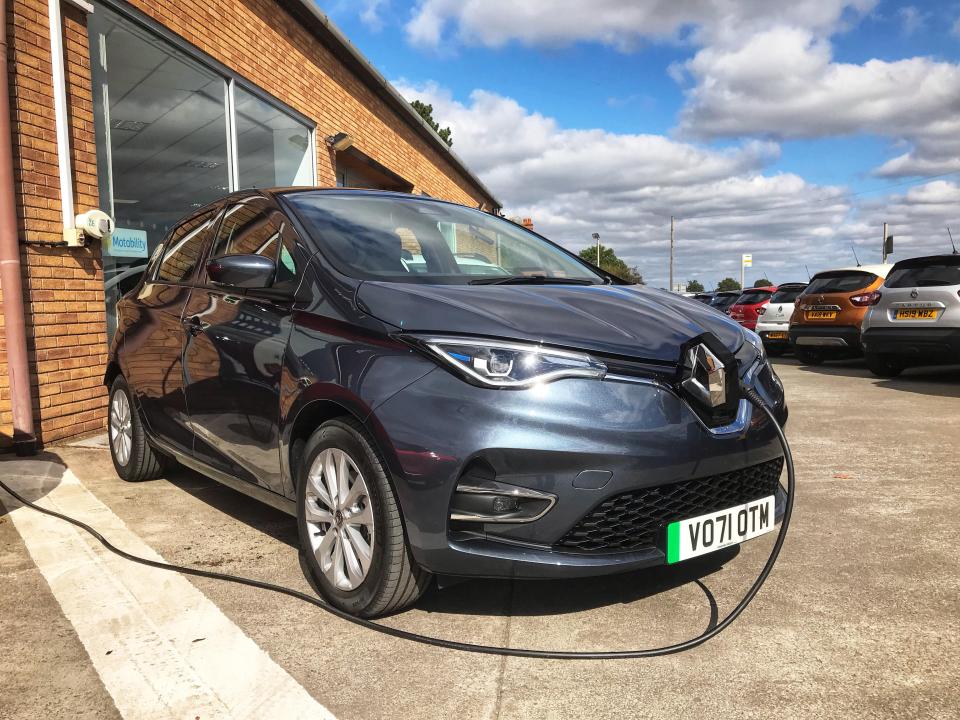 Renault Zoe electric car recharging at a dealership.