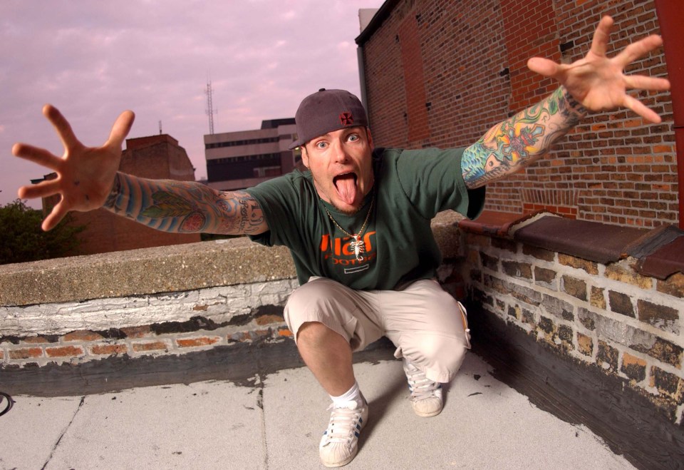 Vanilla Ice sticking his tongue out on a rooftop.