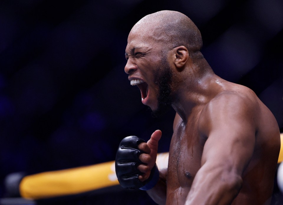 Michael Page celebrating a victory in an MMA fight.