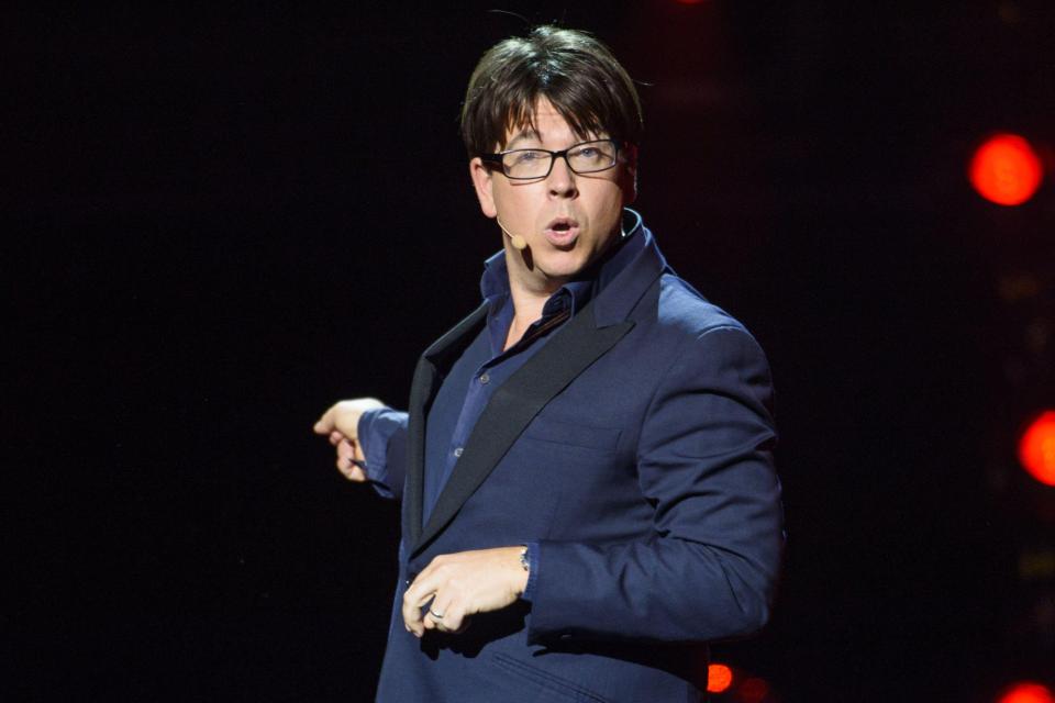 Michael McIntyre performing on stage.