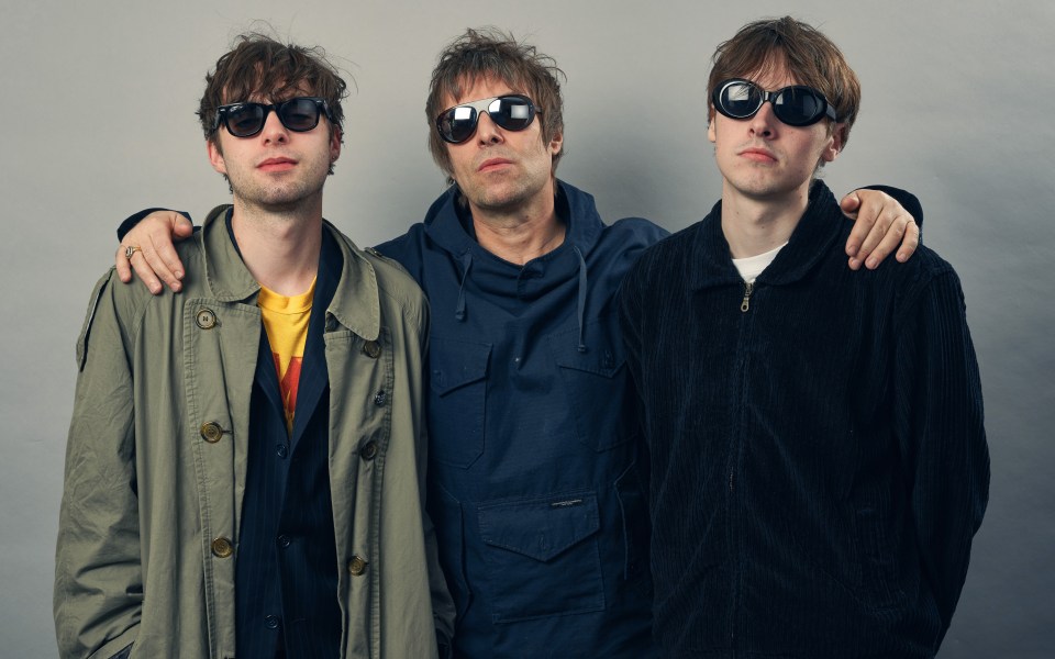 Liam Gallagher and his sons, Gene and Lennon, posing for a photo.