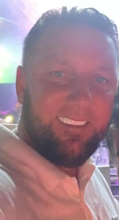 Couple posing for a selfie at a concert.