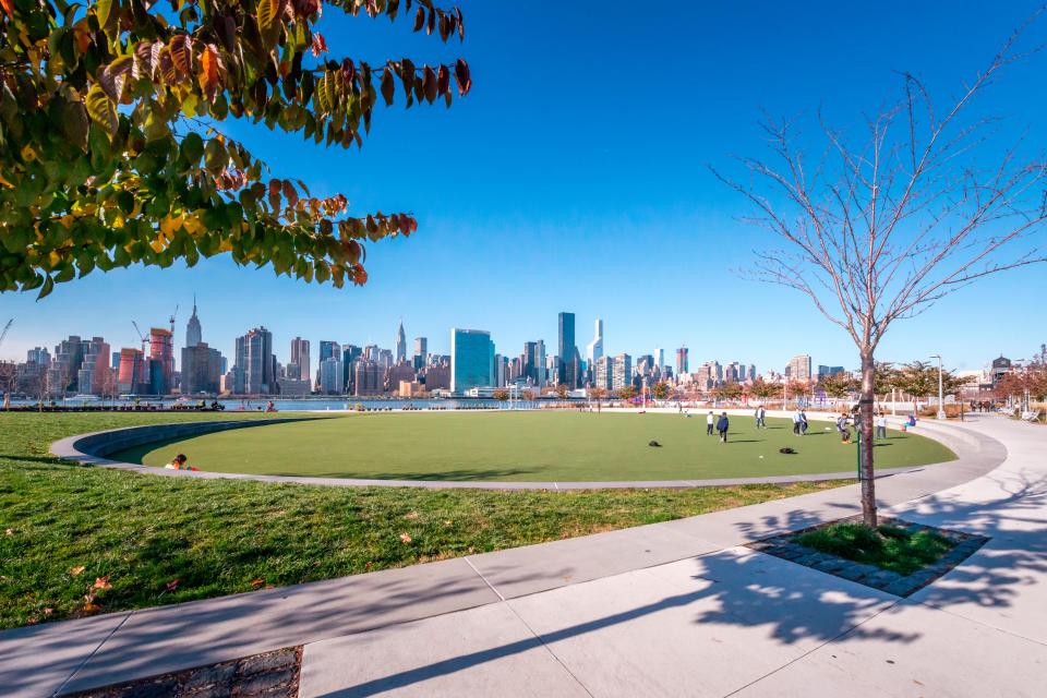 Hunter's Point South Waterfront Park in Long Island City, with the Manhattan skyline in the background.