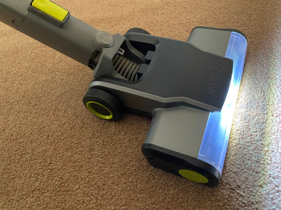 The Ryobi One+ vacuum with its headlights on