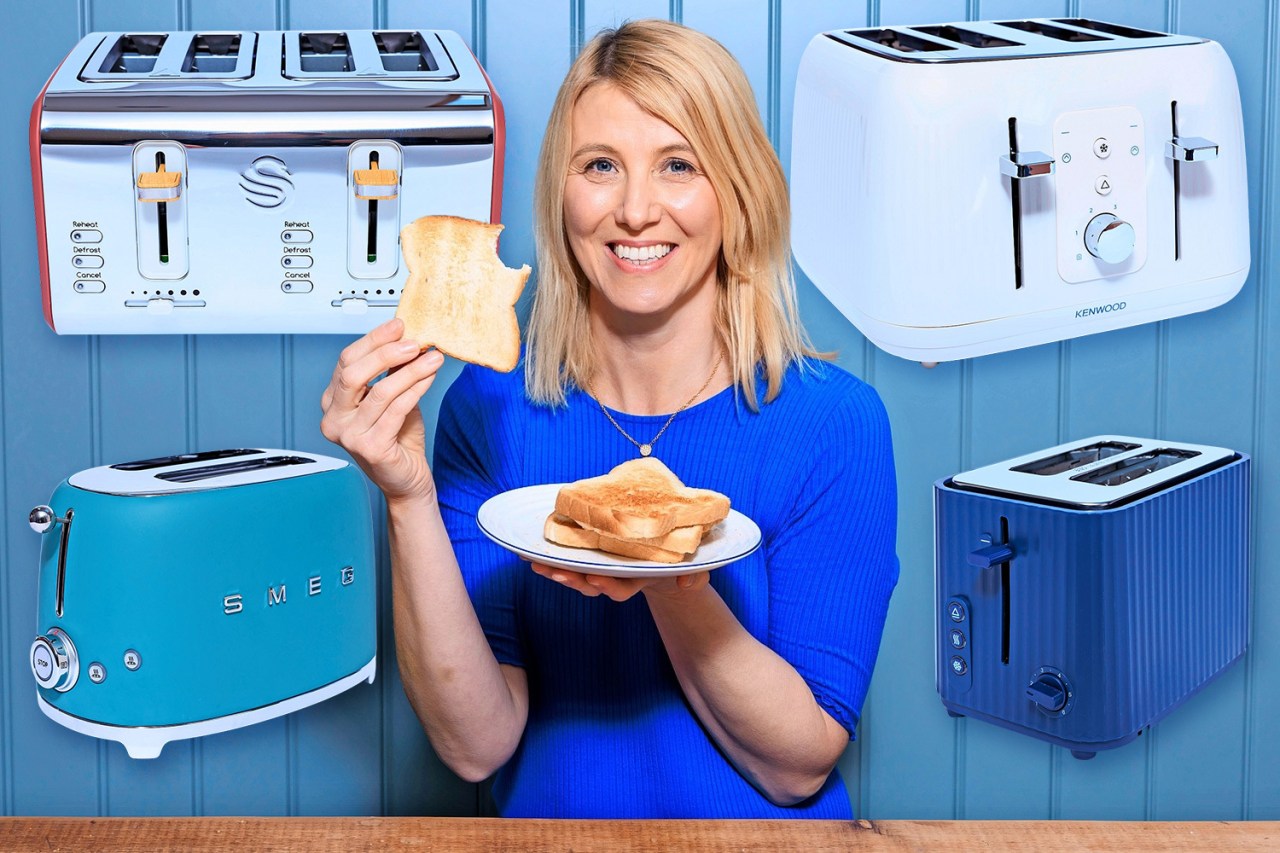 Woman holding toast with various toasters in background.
