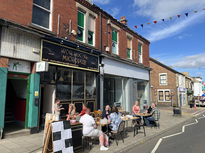 Patrons sitting outside Wor Local micropub.