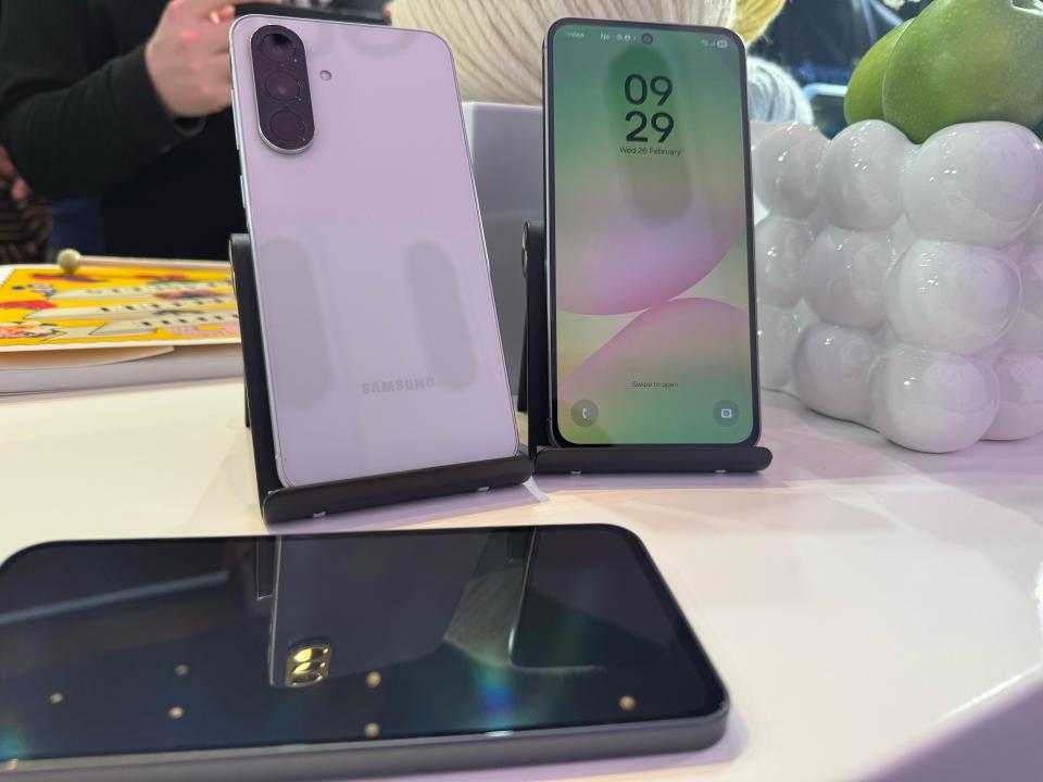 Two Samsung phones displayed on stands.