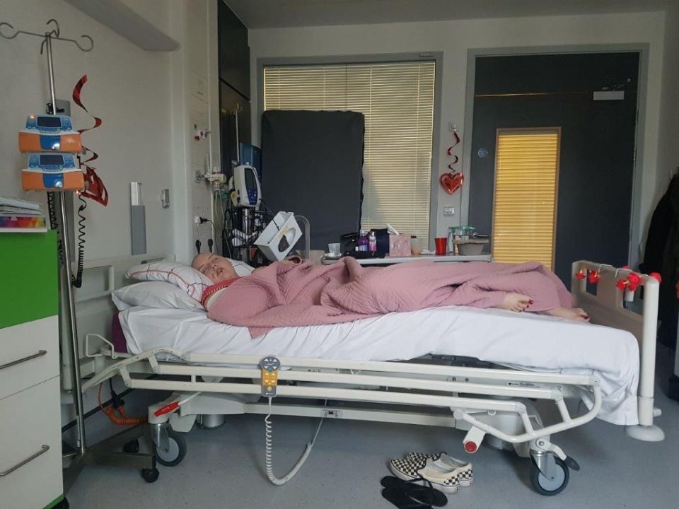 Woman sleeping in a hospital bed.
