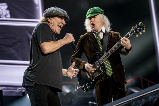 Brian Johnson and Angus Young of AC/DC performing on stage.