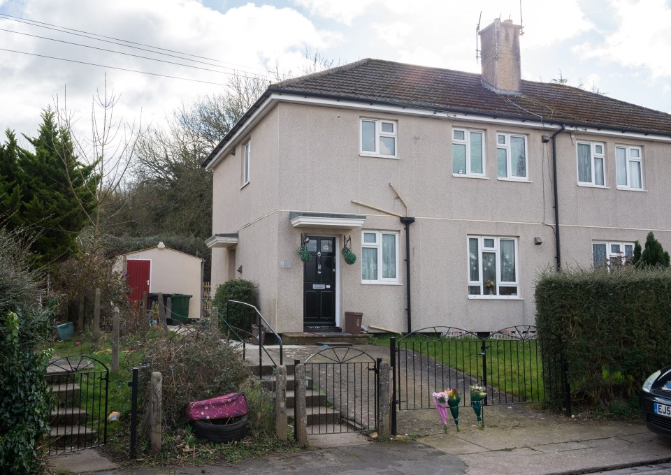 Flowers left outside a house following a fatal dog attack.
