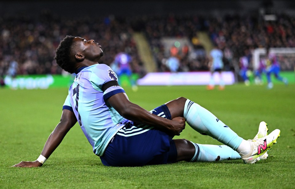 Bukayo Saka of Arsenal injured on the field.