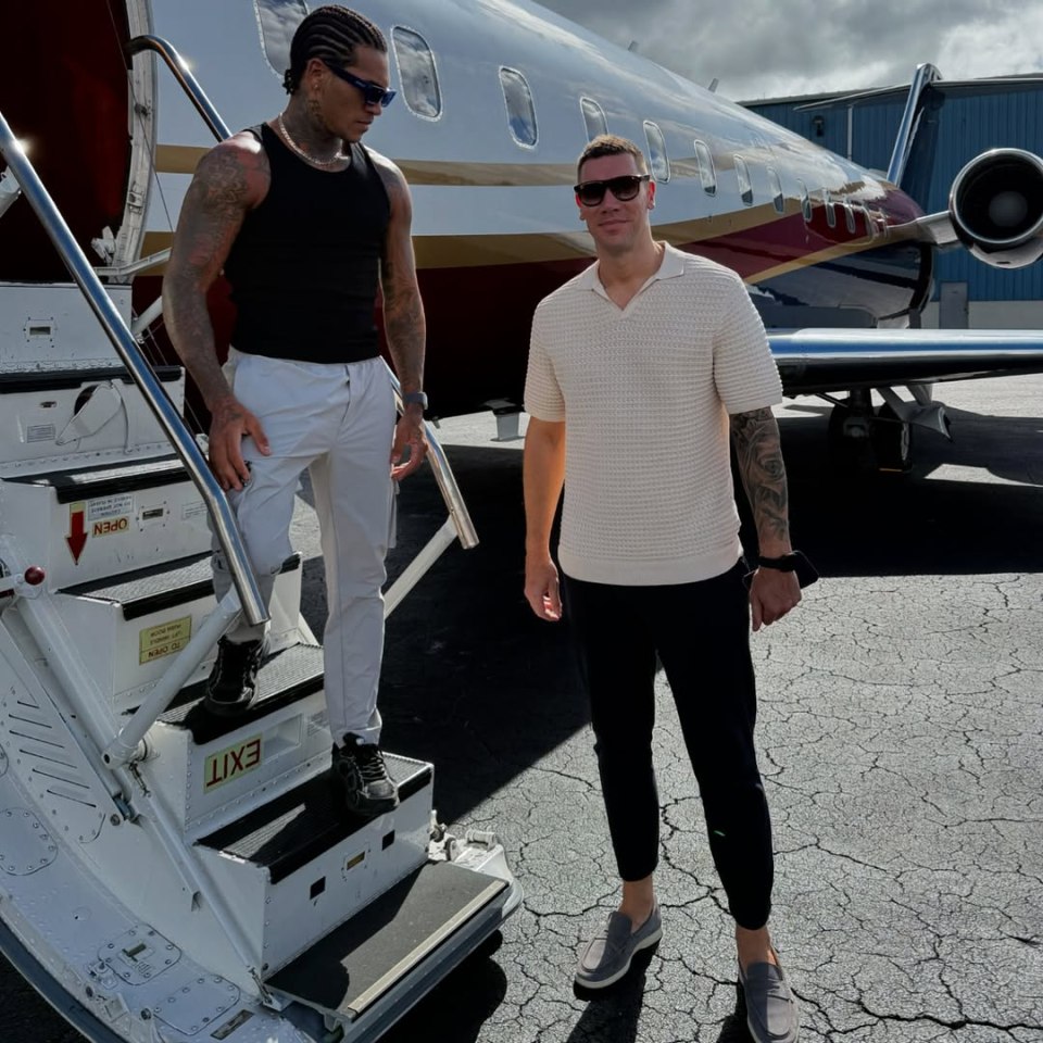 Conor Benn and another man standing by a private jet.
