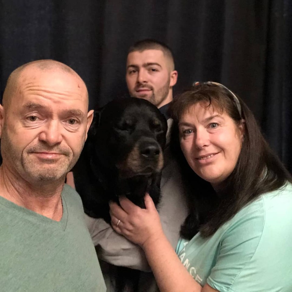 Family portrait with their Rottweiler.