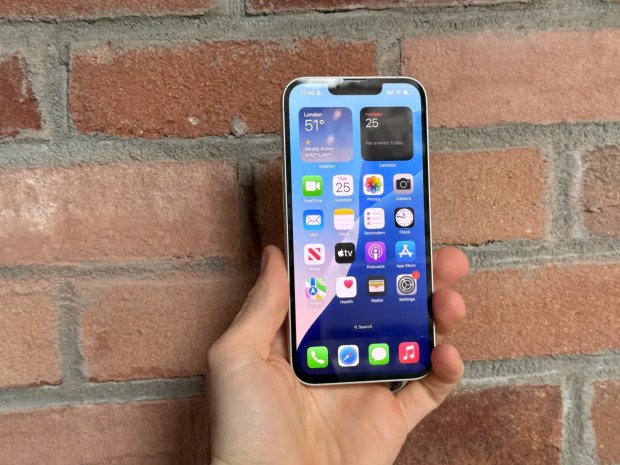 Hand holding iPhone 16e.