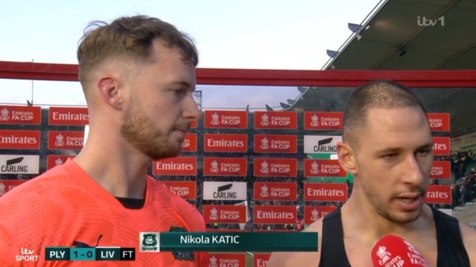Two soccer players being interviewed after a game.