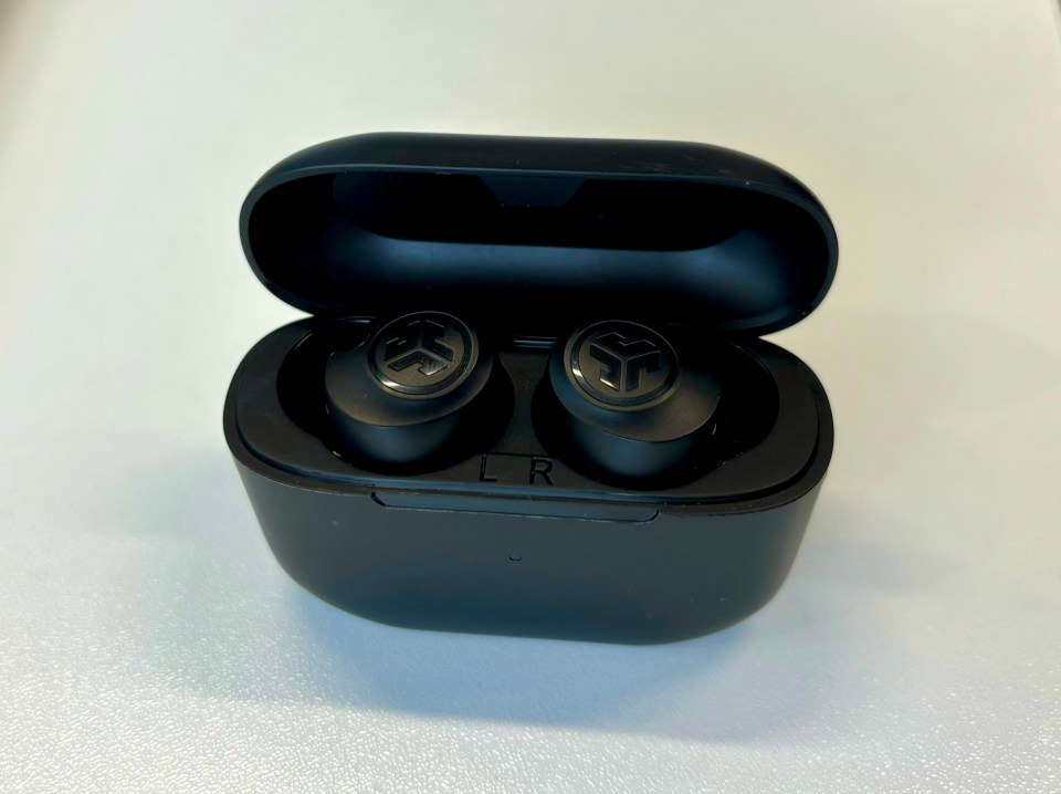 Black wireless earbuds in their charging case.