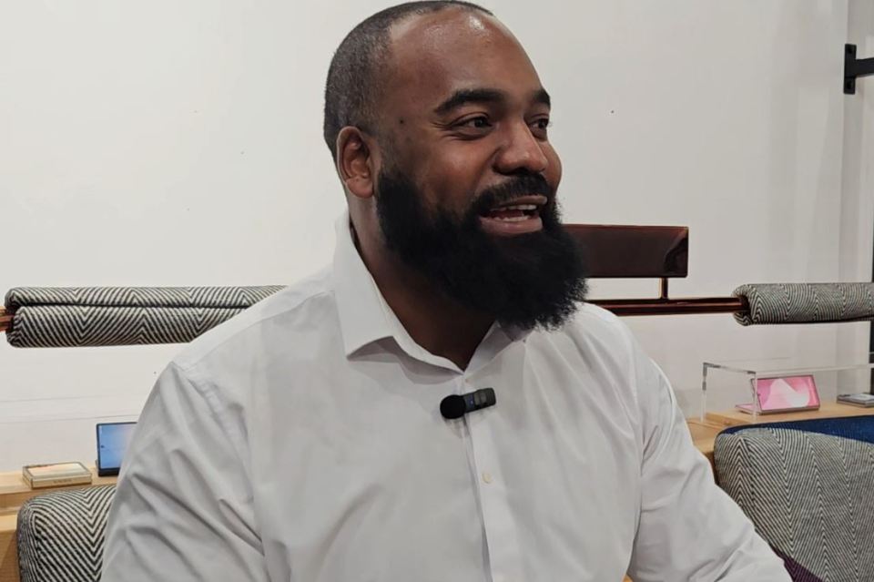 Man with a beard wearing a white shirt.