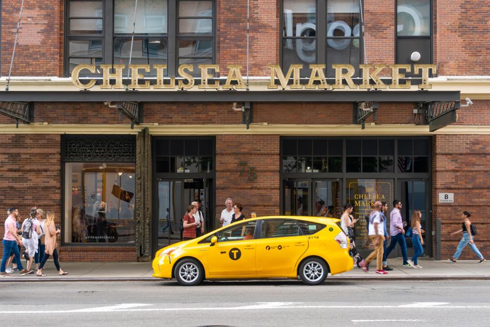 People walking past Chelsea Market in New York City.