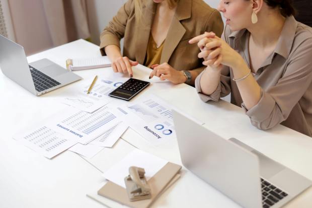 Two businesswomen reviewing financial documents.