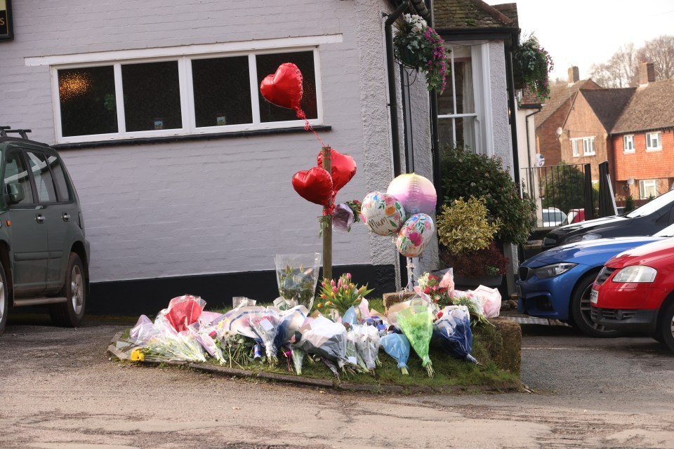 Floral tributes outside a pub following a fatal shooting.