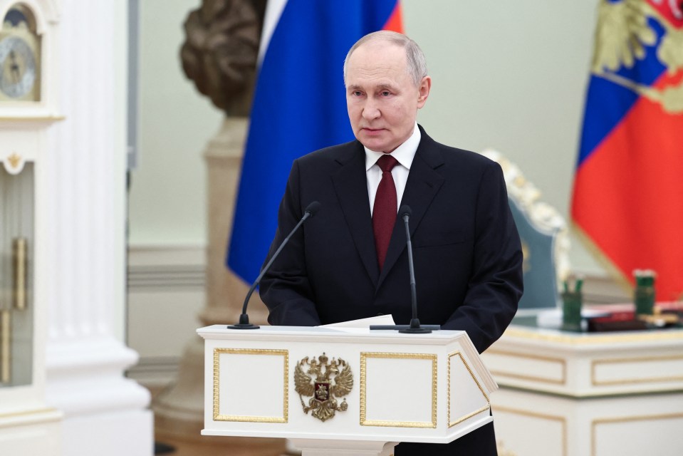 Vladimir Putin giving a speech at an awards ceremony.