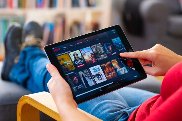 Person using tablet to stream Netflix.