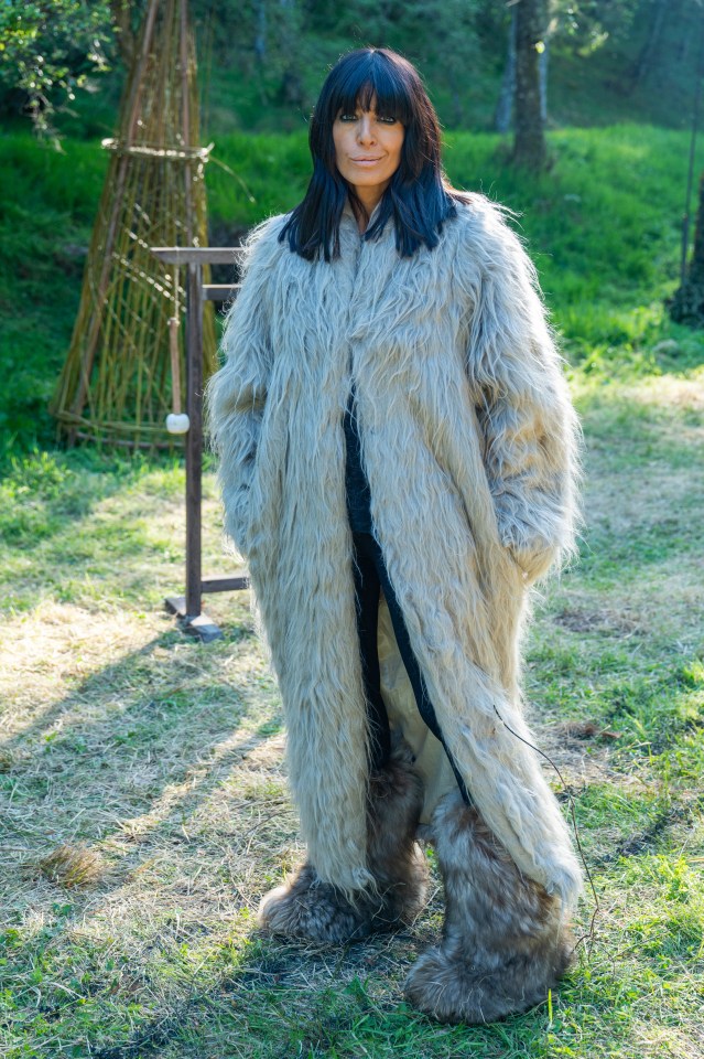 Claudia Winkleman in a long, light-grey fluffy coat and furry boots.