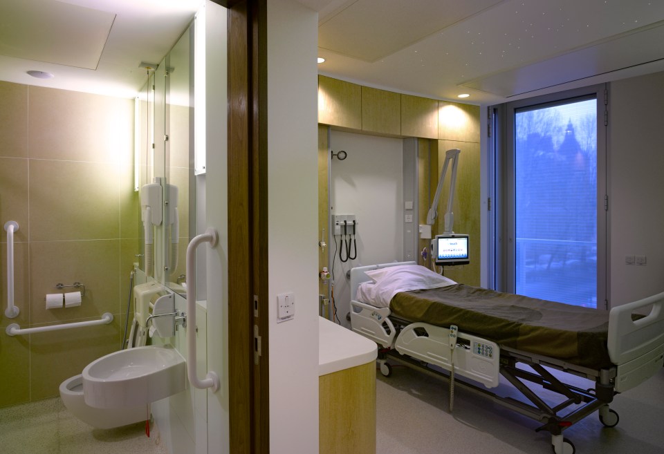 Hospital room with bed and en-suite bathroom.