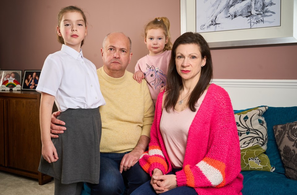 Parents and their two daughters at home.