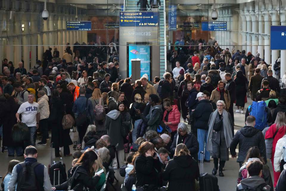 Crowds of passengers waiting at St. Pancras International station.