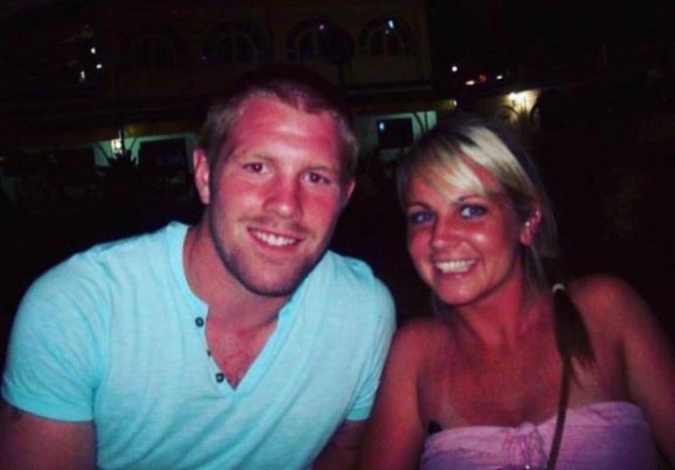Photo of a couple smiling at night.
