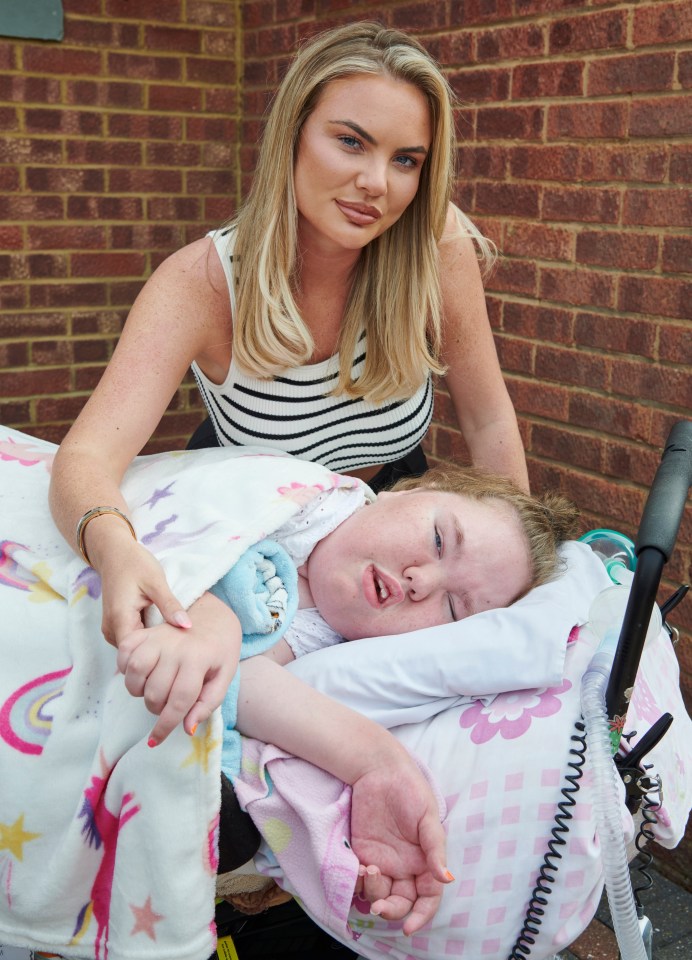 Woman holding hands with her disabled sister.