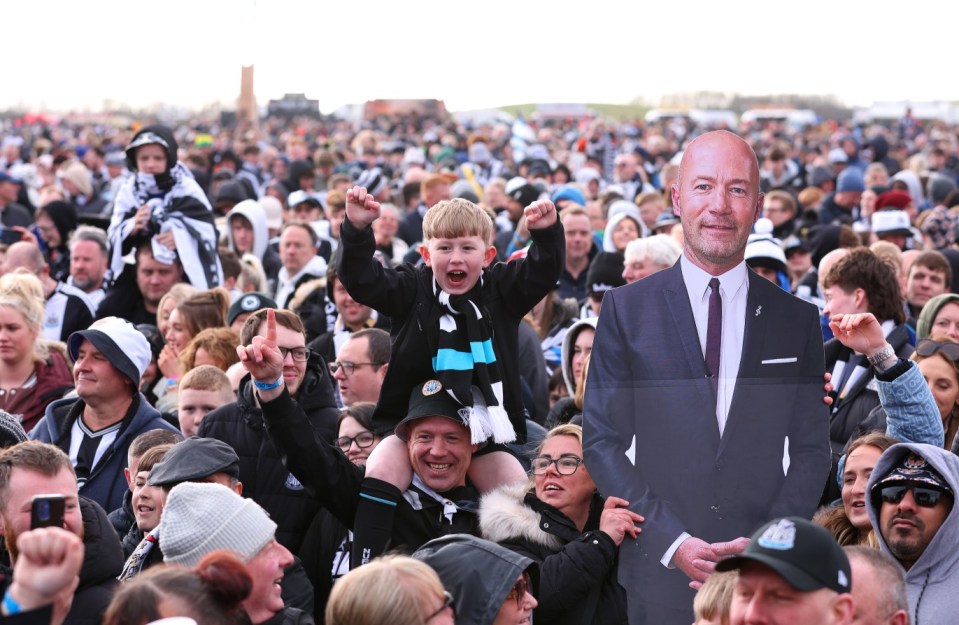 NEWCASTLE UPON TYNE, ENGLAND - MARCH 29: A general view as a fan of Newcastle United holds up a cardboard cut out of Alan Shearer, as other fans enjoy the atmosphere during the Newcastle United trophy parade and celebration on March 29, 2025 in Newcastle upon Tyne, England. Newcastle United defeated Liverpool in the Carabao Cup Final to end their seventy-year domestic trophy drought. (Photo by Ed Sykes/Getty Images)