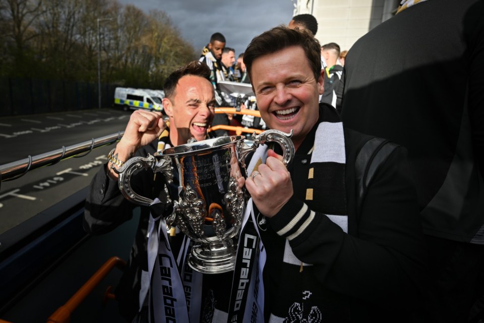 NEWCASTLE UPON TYNE, ENGLAND - MARCH 29: Ant and Dec (Anthony McPartlin, Declan Donnelly) with the Carabao Cup winners trophy during the Newcastle United trophy parade and celebration on March 29, 2025 in Newcastle upon Tyne, England. Newcastle United defeated Liverpool in the Carabao Cup Final to end their seventy-year domestic trophy drought. (Photo by Serena Taylor/Newcastle United via Getty Images)