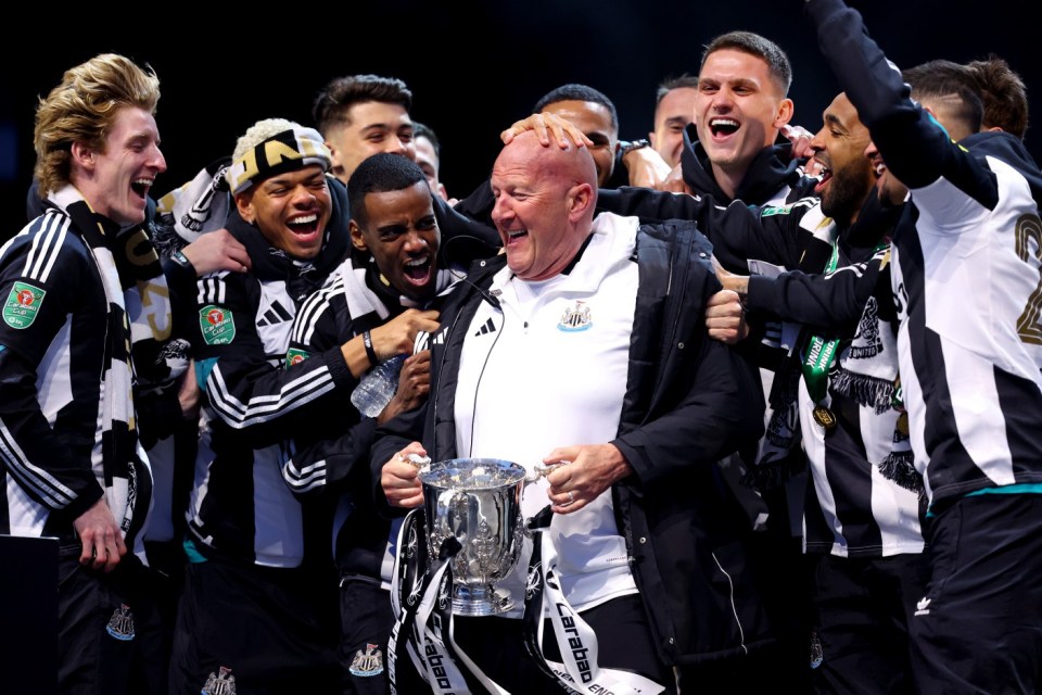 NEWCASTLE UPON TYNE, ENGLAND - MARCH 29: Glenn Patterson, Player Liason Officer of Newcastle United, celebrates with players on stage during the Newcastle United trophy parade and celebration on March 29, 2025 in Newcastle upon Tyne, England. Newcastle United defeated Liverpool in the Carabao Cup Final to end their seventy-year domestic trophy drought. (Photo by Ed Sykes/Getty Images)