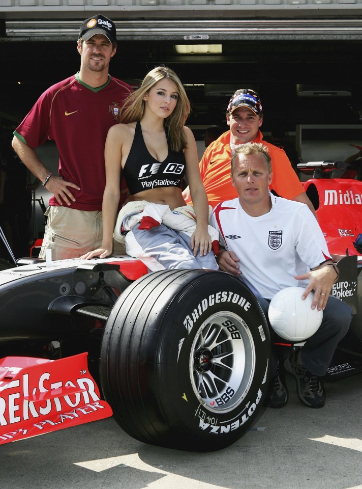 Model Keeley Hazell with Formula One drivers and team personnel.