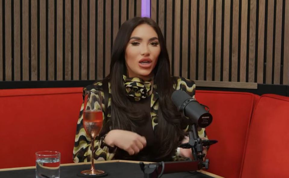 Chloe Brockett on a podcast, speaking into a microphone.