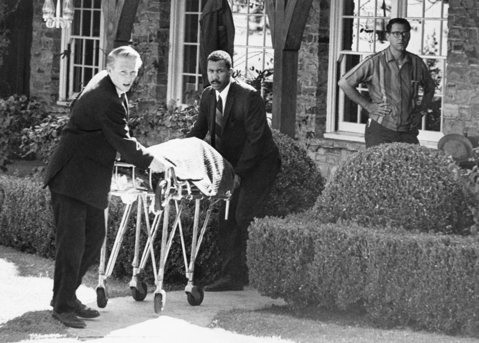 Coroner's office personnel wheeling Sharon Tate's body.