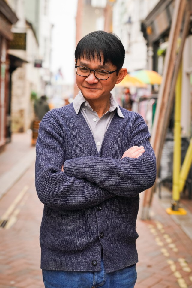 Portrait of Danny Luong, arms crossed.