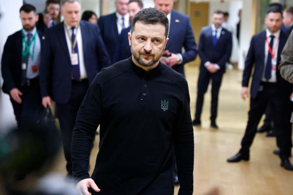Volodymyr Zelensky walking in an EU headquarters corridor.