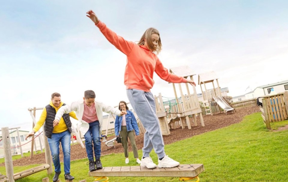Family having fun at an outdoor playground.