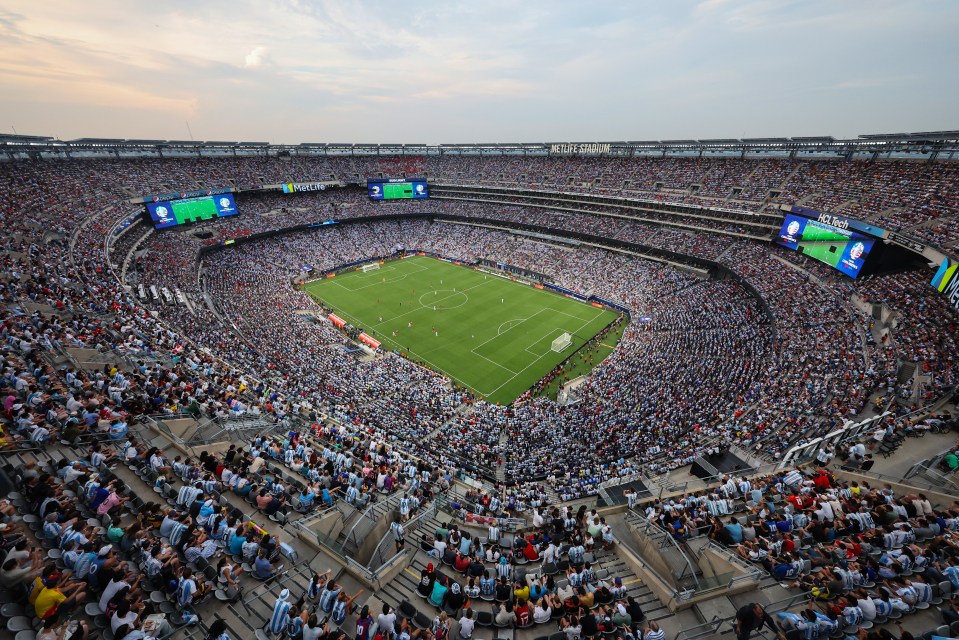 Aerial view of a full stadium during a soccer match.