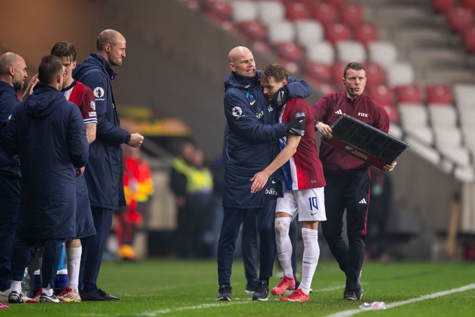 Ståle Solbakken and Martin Ødegaard embracing after a soccer match.