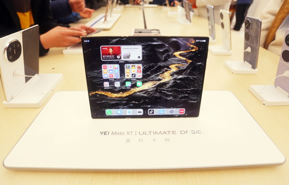 Huawei Mate XT folding phone on display.