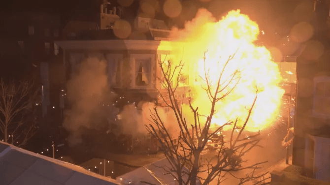 Building engulfed in flames and smoke.